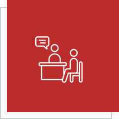 Two figures talking at a table icon.