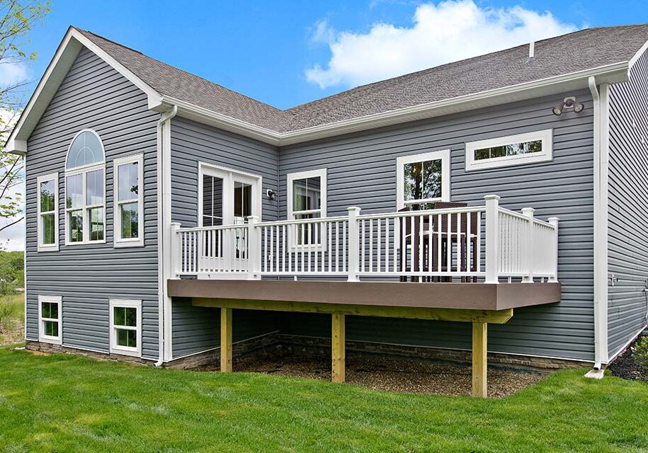 Gray house with white deck and windows.
